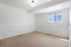 Spare room with light carpet and ornamental molding