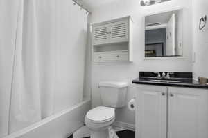 Full bathroom featuring vanity and shower / bath combination with curtain