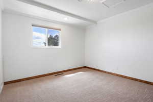 Spare room with crown molding, light carpet, and recessed lighting