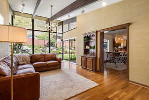 Living area featuring light wood finished floors and hanging lights