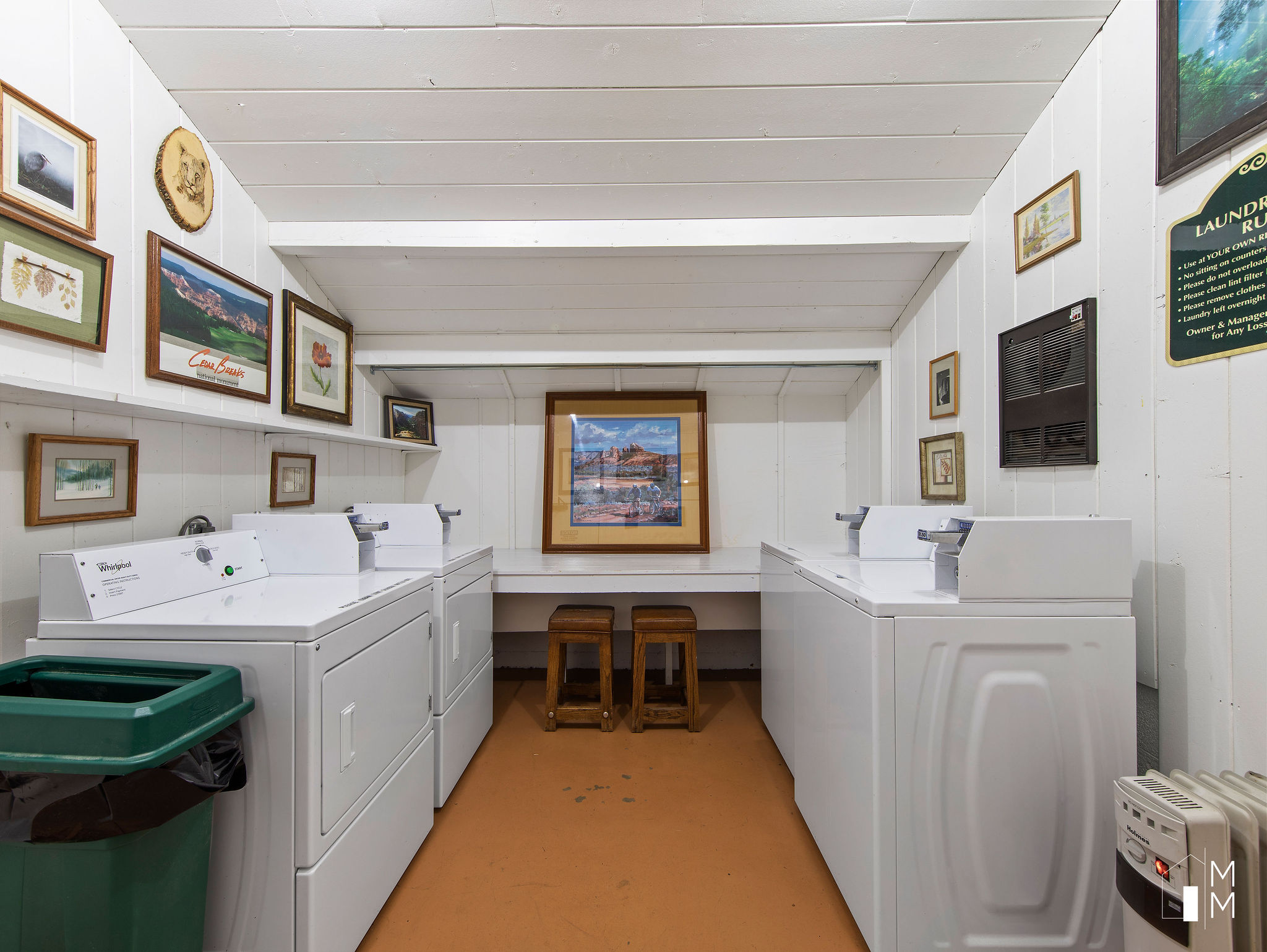 Shared laundry featuring washer and clothes dryer, wood walls, and a vaulted wooden ceiling