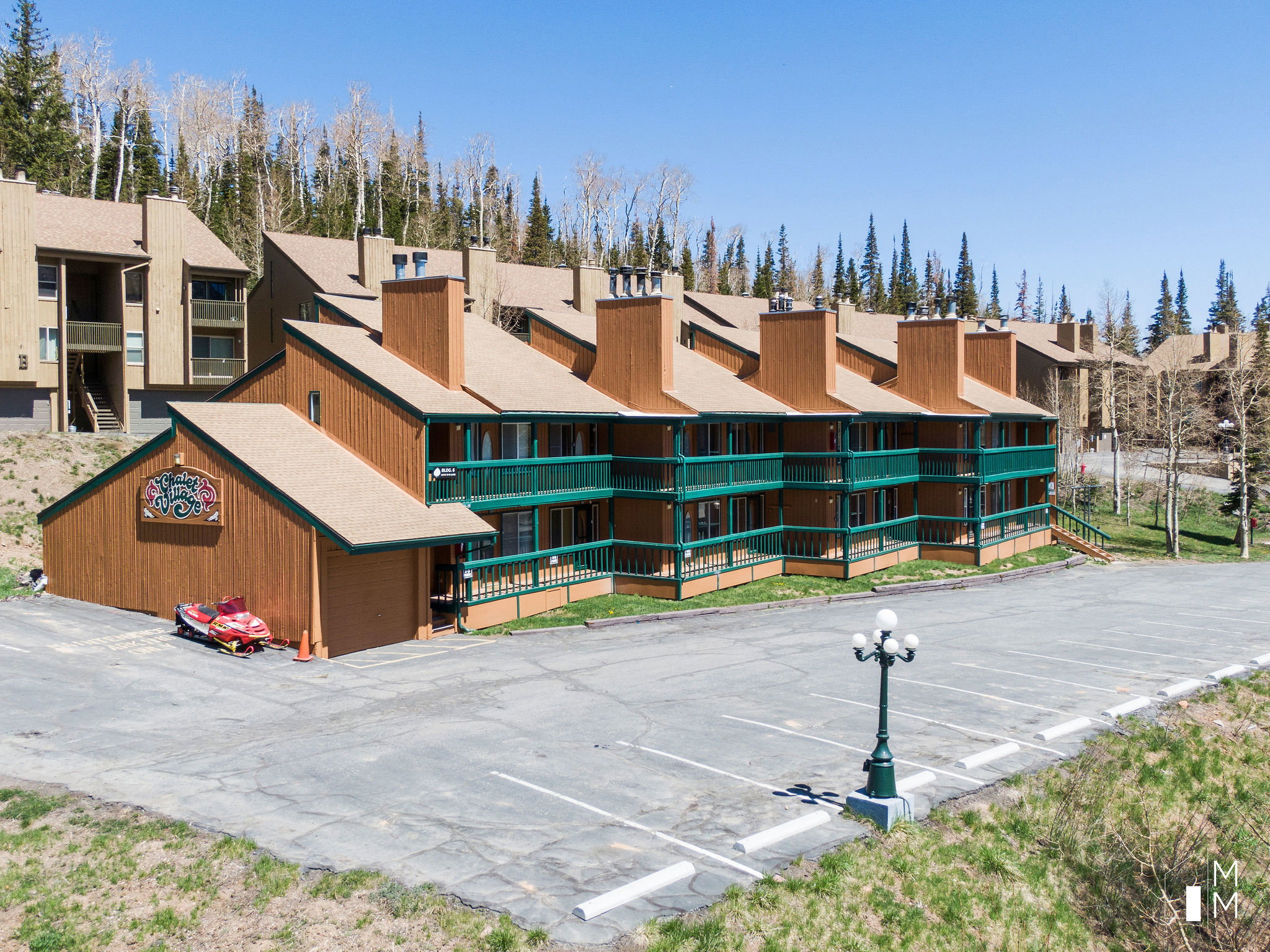 View of apartment building / complex featuring uncovered parking