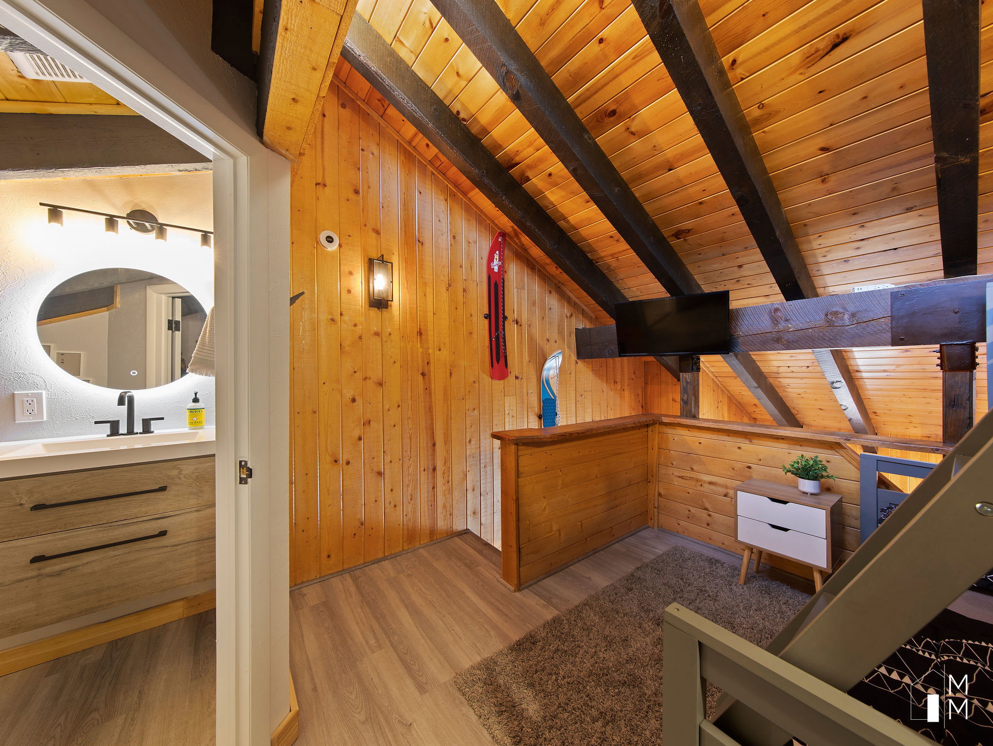Bedroom with light wood-type flooring, wood walls, and a wooden ceiling with exposed beams