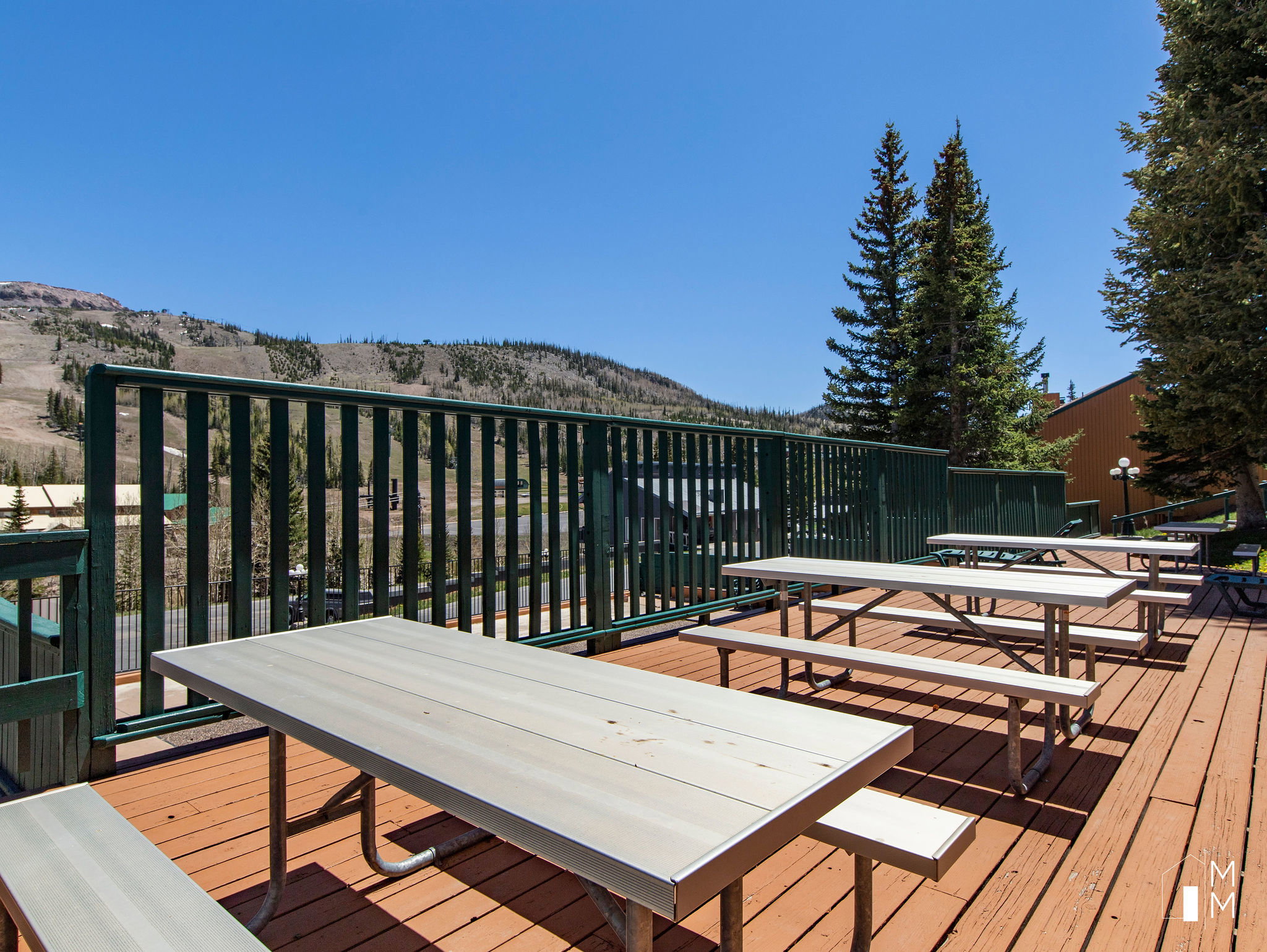Wooden deck with a mountain view and outdoor dining area