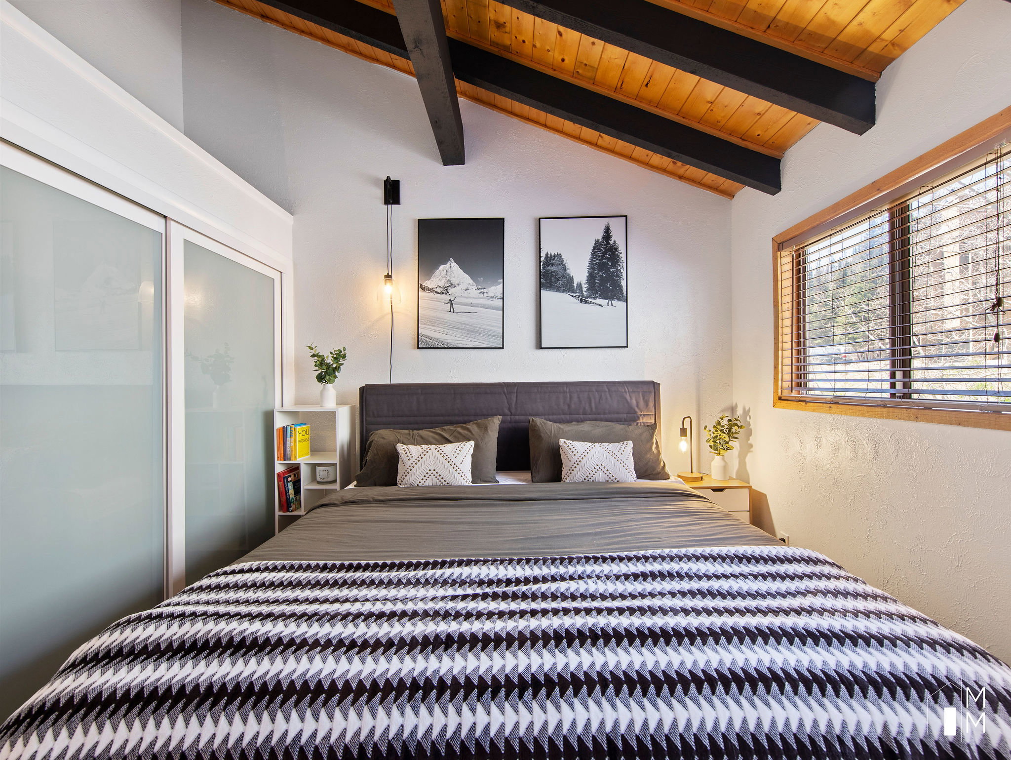 Bedroom with lofted ceiling with beams, a textured wall, and wooden ceiling