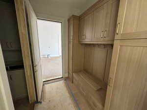 Mudroom with light wood-style flooring