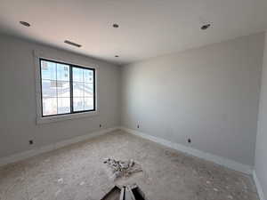 Empty room featuring baseboards