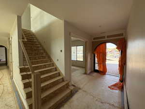 Entrance foyer with arched walkways and stairway