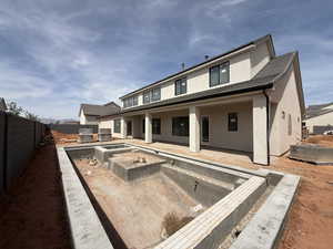 Rear view of property with a patio area, stucco siding, and a fenced backyard