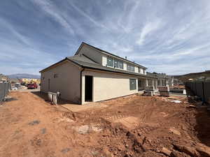 Back of property featuring a fenced backyard, stucco siding, and a mountain view