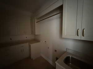 Laundry area with hookup for a washing machine and cabinet space