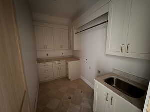 Laundry area with cabinet space and hookup for a washing machine