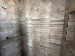 Full bath featuring a tile shower and a sauna