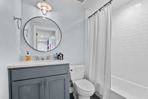 Full bath featuring vanity and shower / bathtub combination with curtain