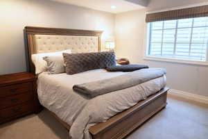 Bedroom with light colored carpet