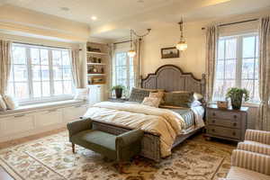 Bedroom featuring light wood-style floors, multiple windows, and wood ceiling