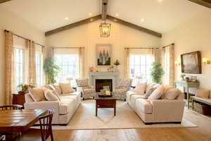 Living area with light wood-style flooring, a fireplace, and recessed lighting
