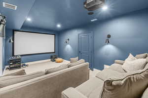 Carpeted home theater room featuring baseboards and recessed lighting