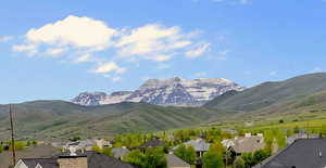 View of mountain backdrop featuring nearby suburban area