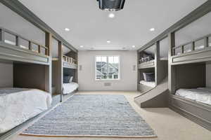 Bedroom with light colored carpet and recessed lighting