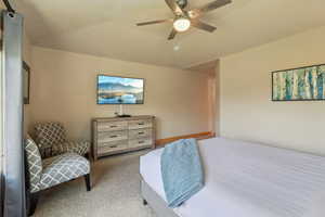 Bedroom featuring light colored carpet and a ceiling fan