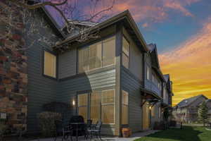 Back of house at dusk with a patio