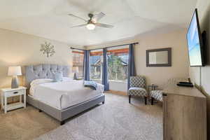 Bedroom with light colored carpet and ceiling fan