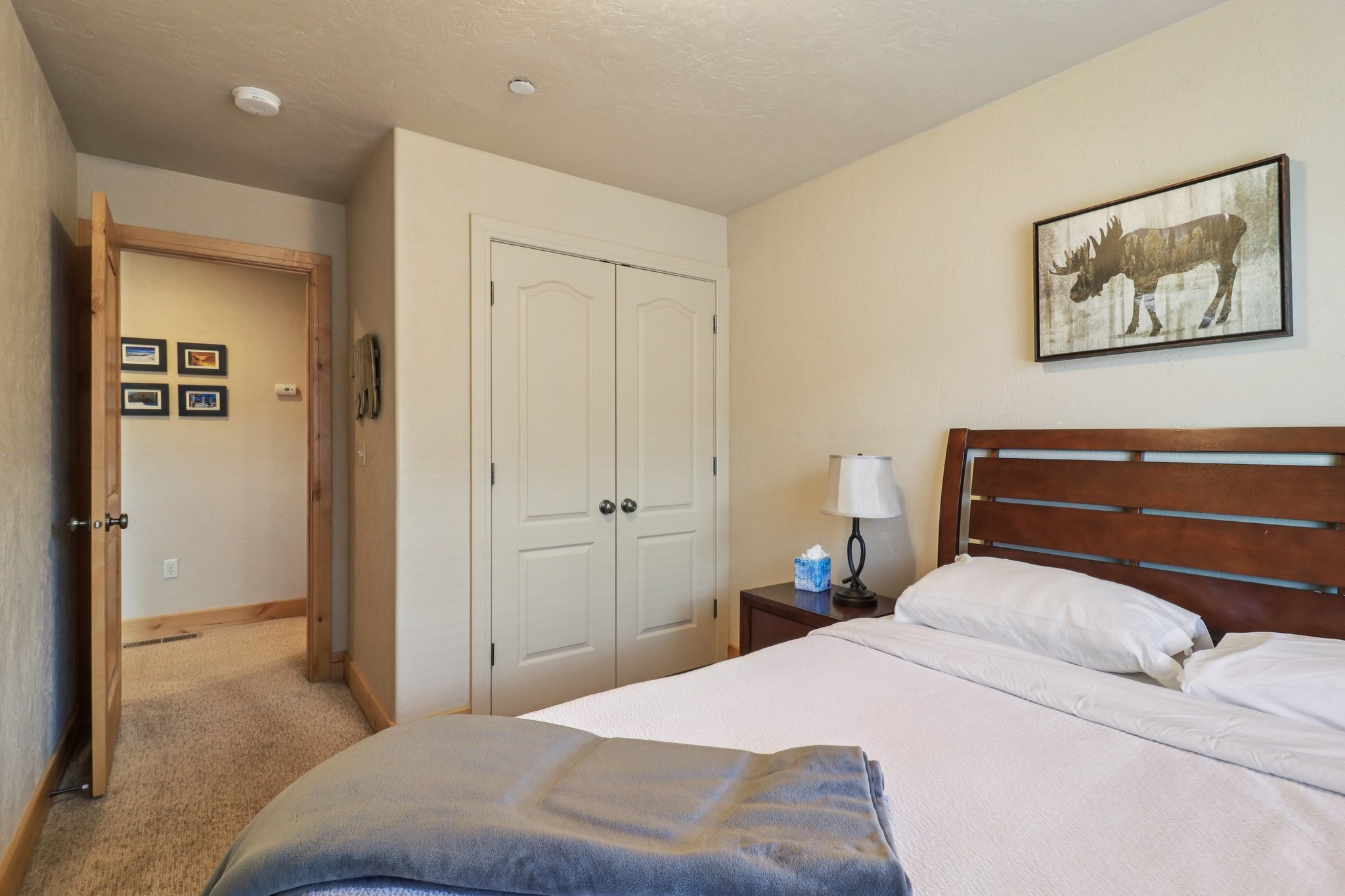 Bedroom featuring light carpet and a closet