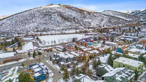Snowy aerial view featuring a mountain view