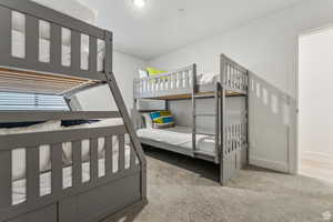 Bedroom featuring light carpet and baseboards