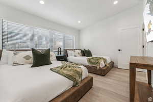 Bedroom featuring wood finished floors, recessed lighting, and vaulted ceiling