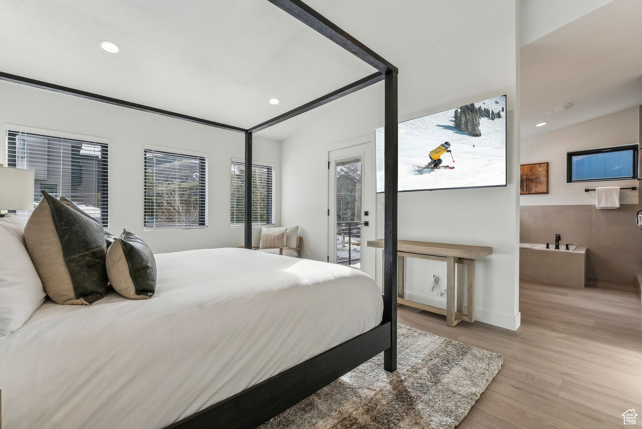 Bedroom with light wood-type flooring, recessed lighting, and access to exterior