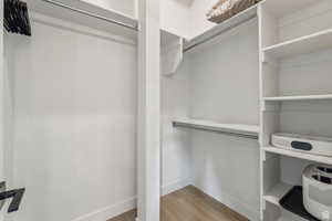 Walk in closet featuring light wood-style floors