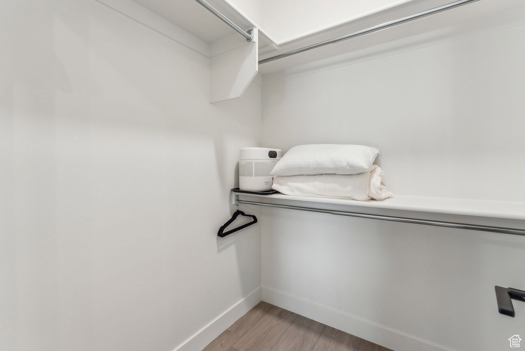 Walk in closet featuring light wood-type flooring