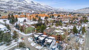 Snowy aerial view featuring a mountain view