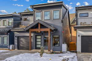View of front of house featuring a balcony and an attached garage