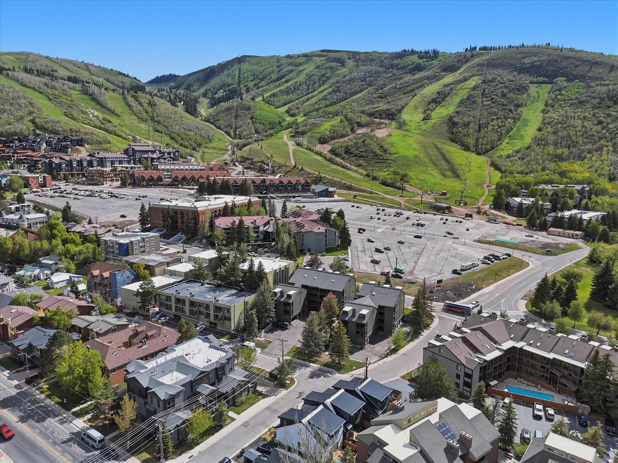 Aerial perspective showcasing a mountain landscape with multiple residential and commercial structures