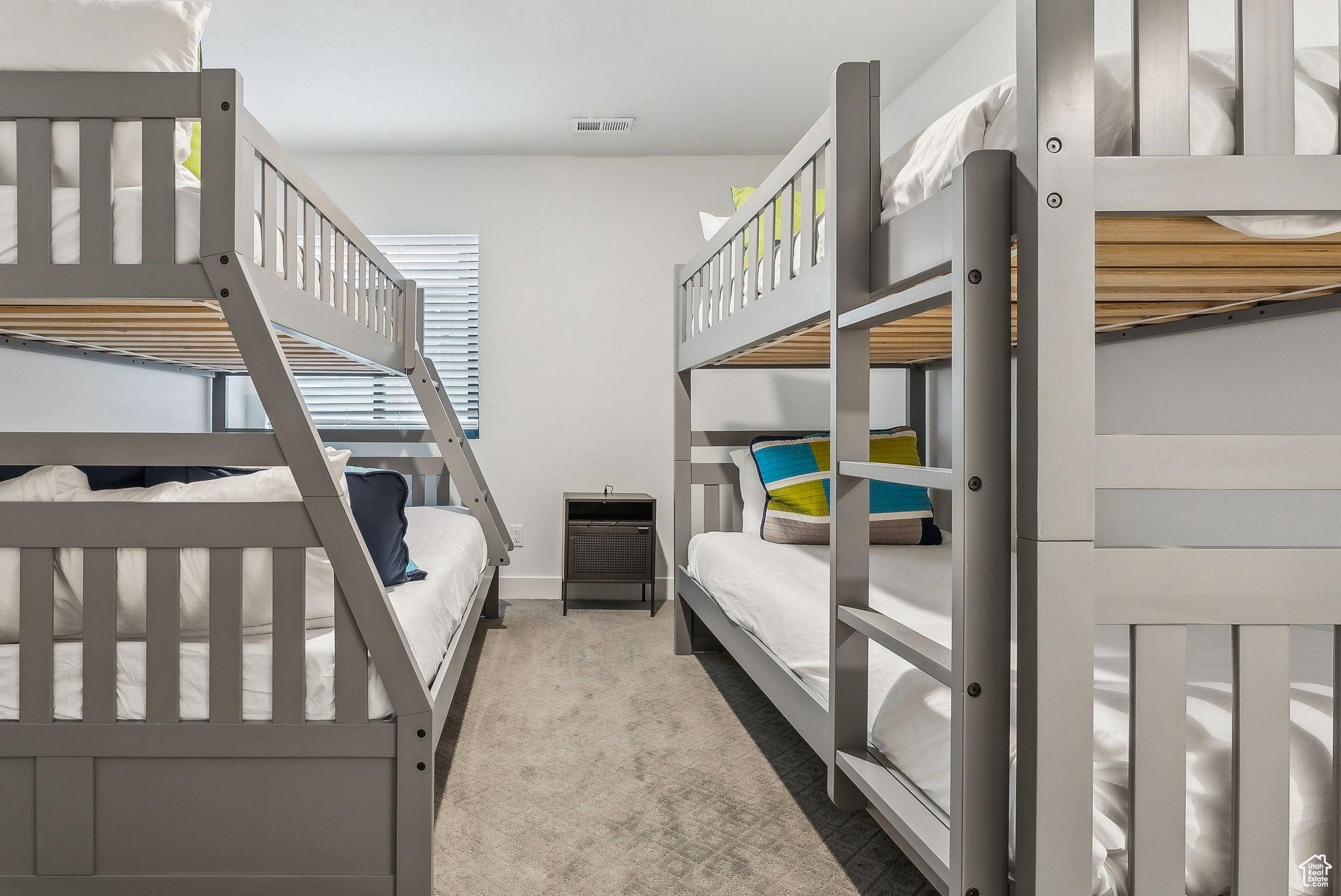 Bedroom with light carpet and baseboards