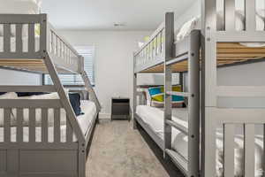 Bedroom with light carpet and baseboards