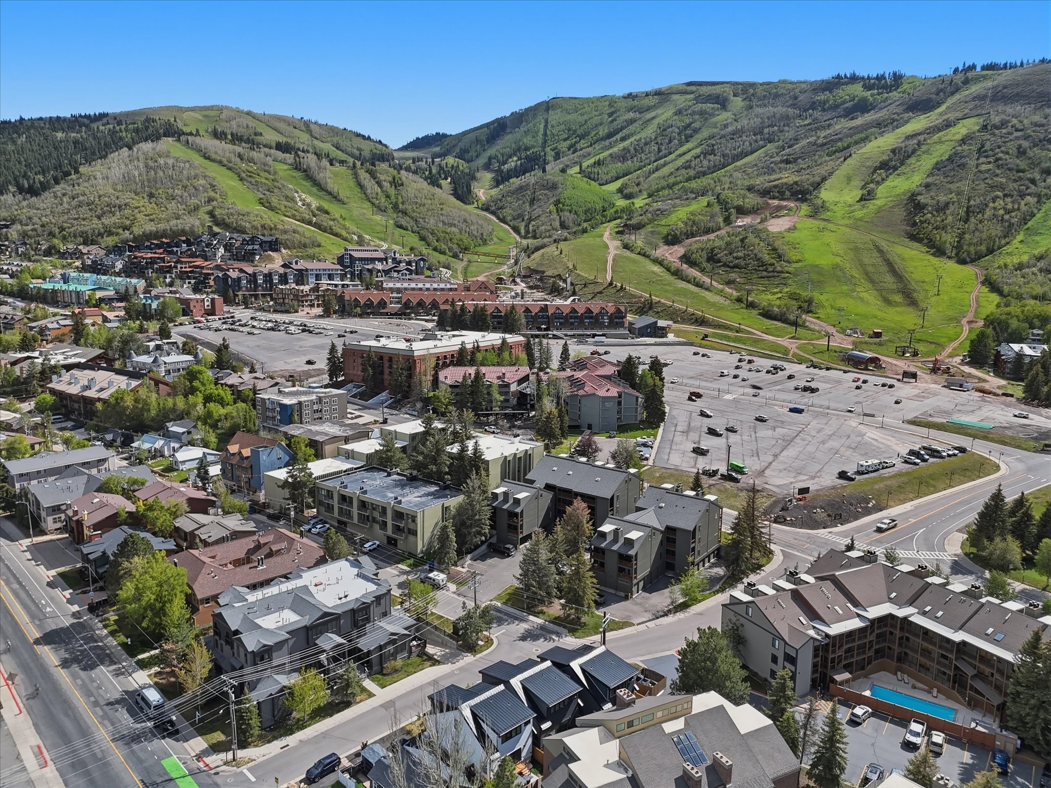 Aerial perspective showcasing a vibrant community nestled against verdant mountainsides