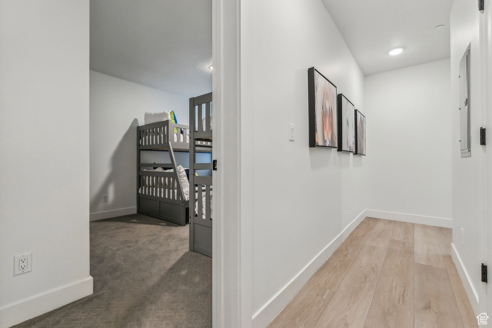 Hallway with light carpet and recessed lighting