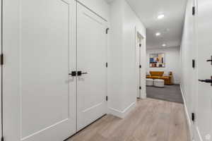 Hallway featuring light wood-style floors and recessed lighting