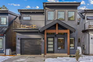 View of front facade featuring concrete driveway and an attached garage