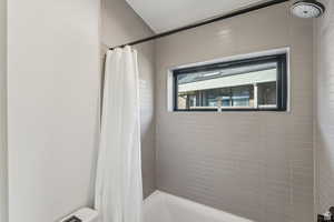 Full bath with shower / tub combo with curtain and toilet