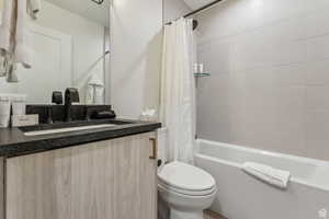 Full bathroom with vanity and shower / bath combination with curtain