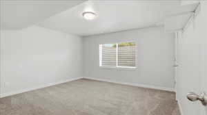 Unfurnished room featuring light colored carpet and baseboards
