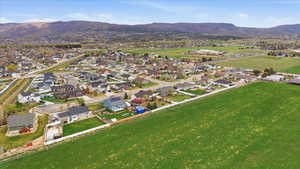 Aerial view of property's location with a mountainous background and nearby suburban area