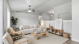 Living room featuring vaulted ceiling, ceiling fan, and wood finished floors