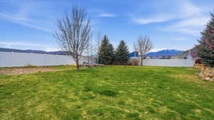 Fenced backyard with a mountain view