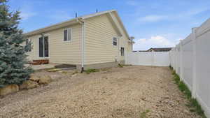 View of home's exterior featuring a fenced backyard and a patio area